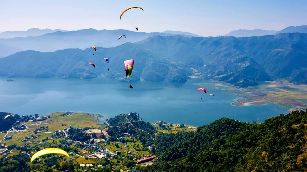 Paragliding at Pokhara over Phewa Lake with Annapurna mountains in the background