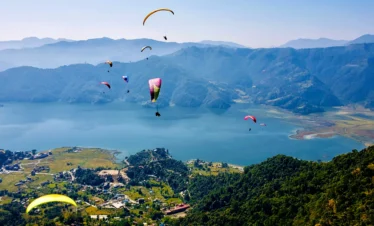 Paragliding at Pokhara over Phewa Lake with Annapurna mountains in the background